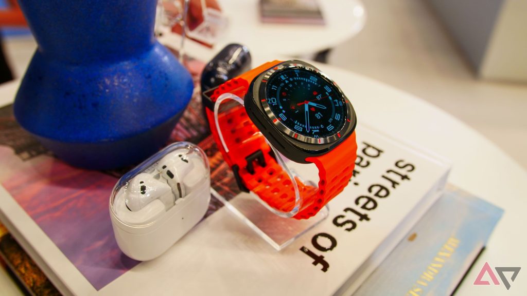 Samsung Galaxy Watch Ultra On Table Next To Buds 1.jpg