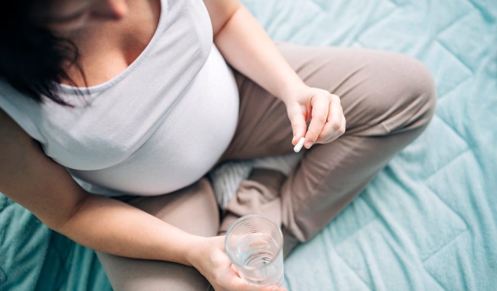 Pregnant Woman Taking Pill.jpg