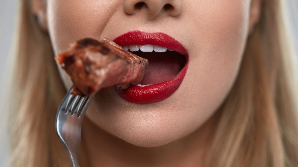 Woman Eating Steak.jpg