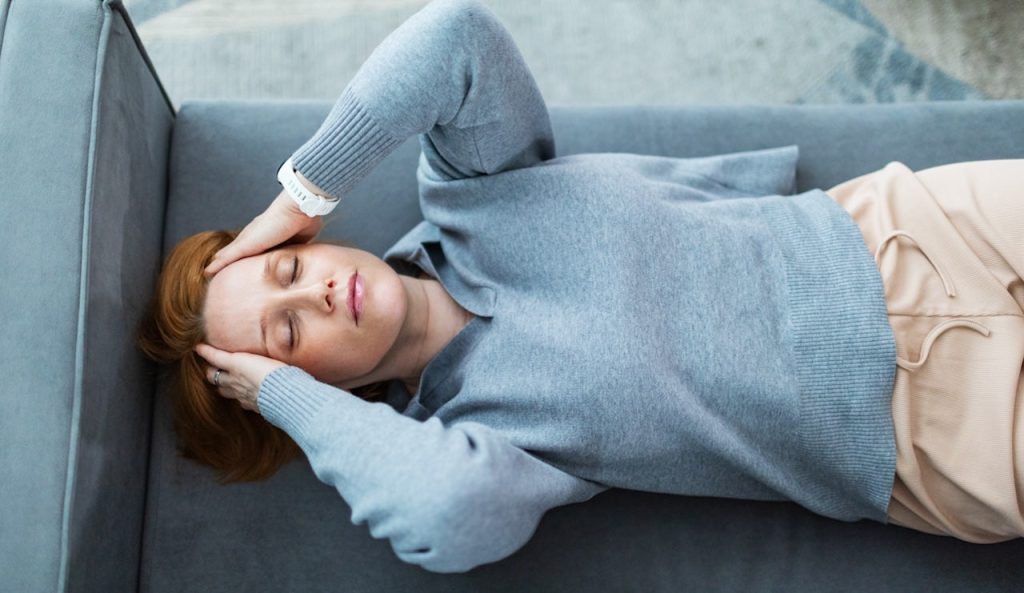 Woman Laying Down Headache.jpg