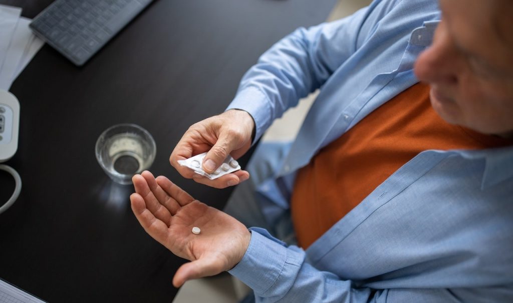 Older Man Taking Pill.jpg