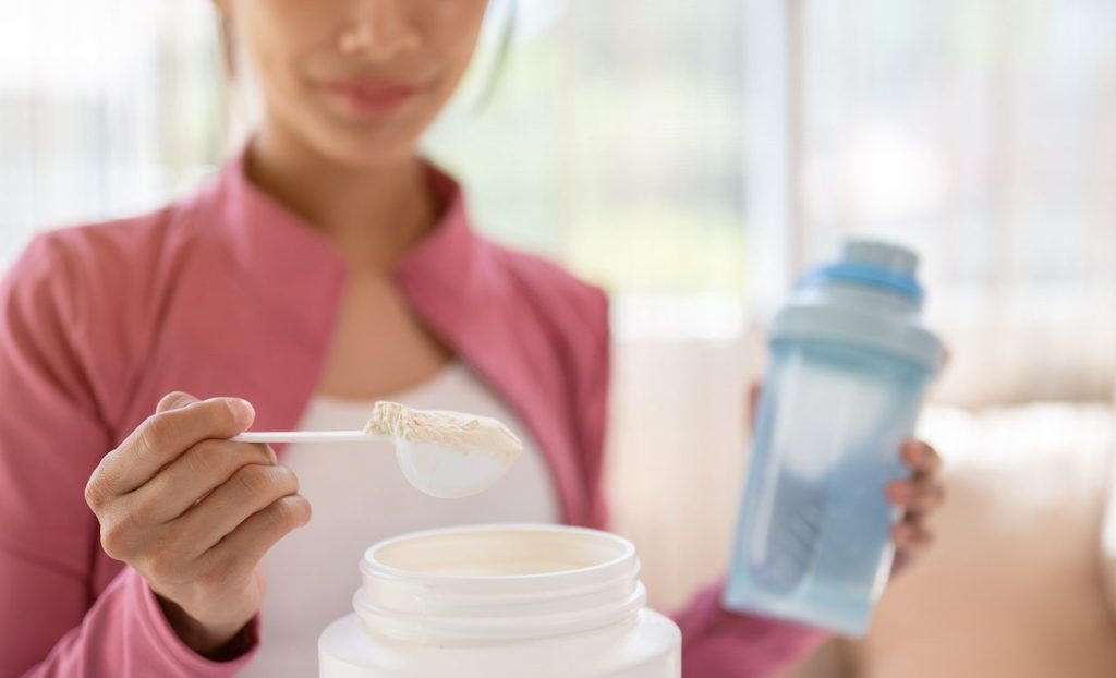 Popular sports supplement shown ineffective in study Woman Scooping Creatine.jpg