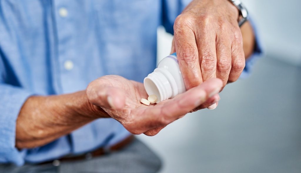 Older Man Taking Pills.jpg