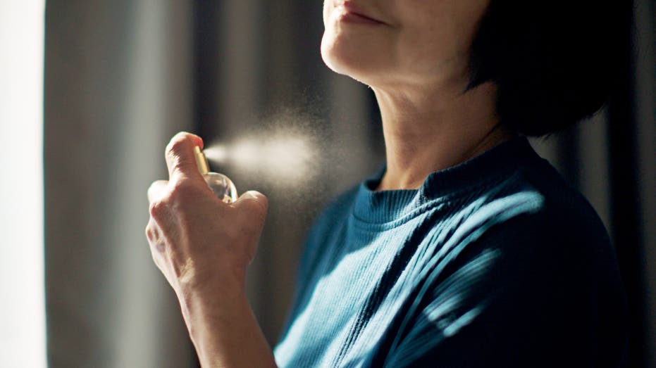 'Old people smell' is real, experts say — here's how to avoid it as you age Older woman putting on perfume scaled.jpg