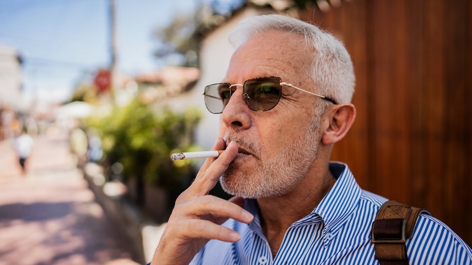Smoking just two cigarettes a day can wreak havoc on your heart, study shows Older man smoking cigarette.jpg