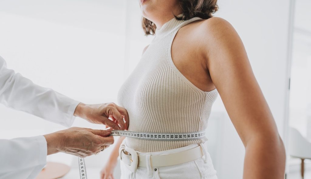 New weight loss drug shows up to 20% results in clinical study trials Woman measuring belly fat.jpg