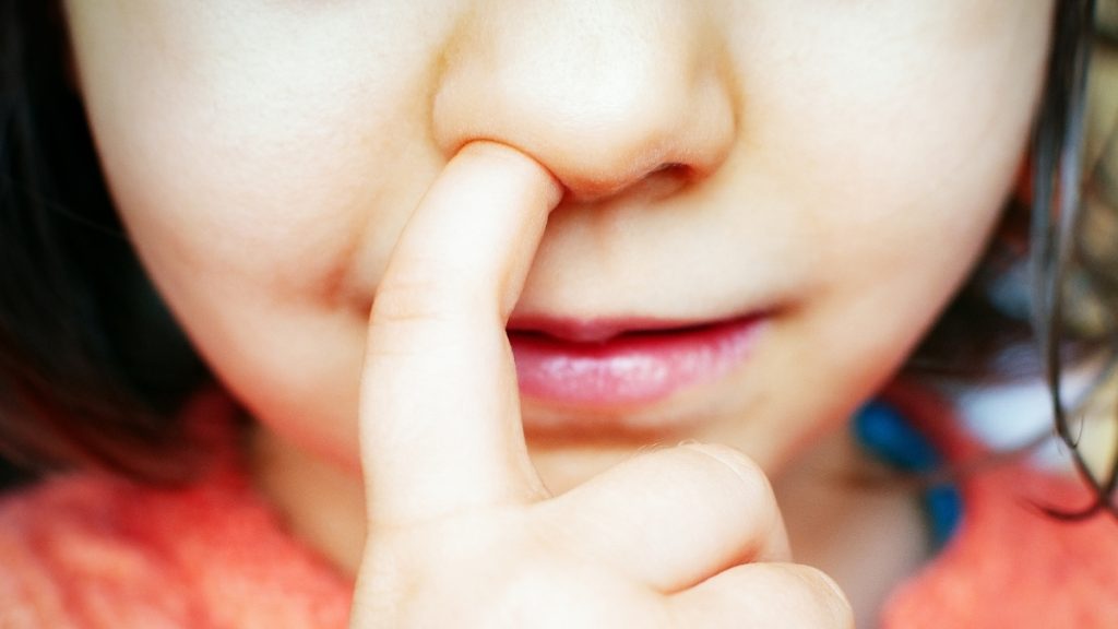 Close up of girl picking nose stock photo.jpg