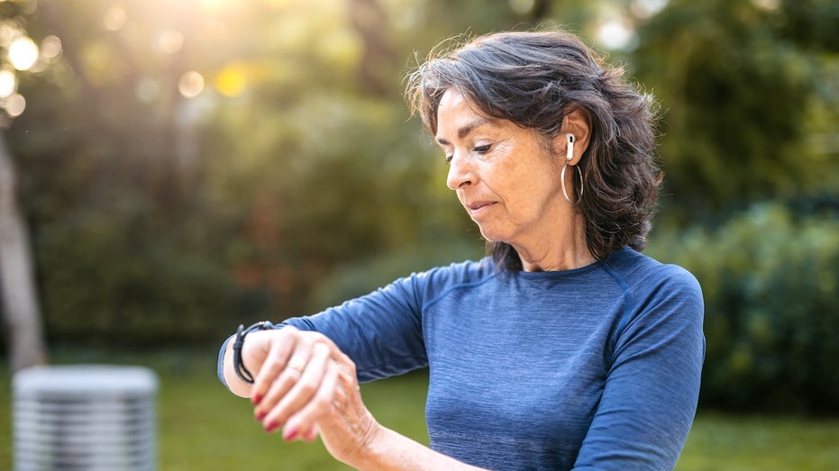 Hidden heart changes may be triggered by exercise, new research reveals Older woman exercising checking heart rate.jpg