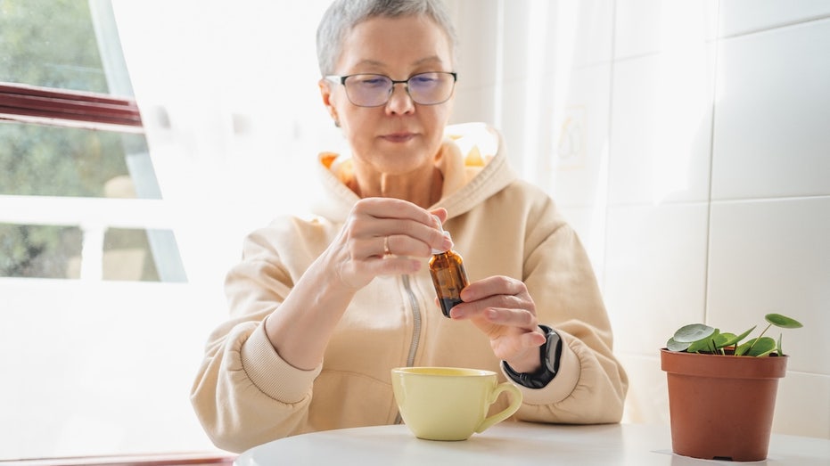 Major cannabis study finds little proof for popular medical claims, flags big dangers Older woman taking cannabis oil.jpg