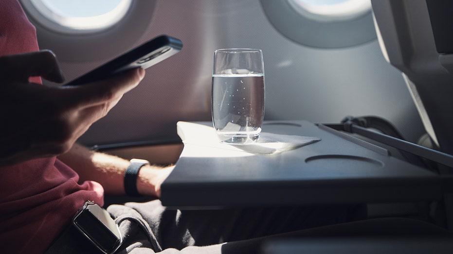 Flight passengers warned as airline water systems test positive for contamination Glass of water on airplane.jpg