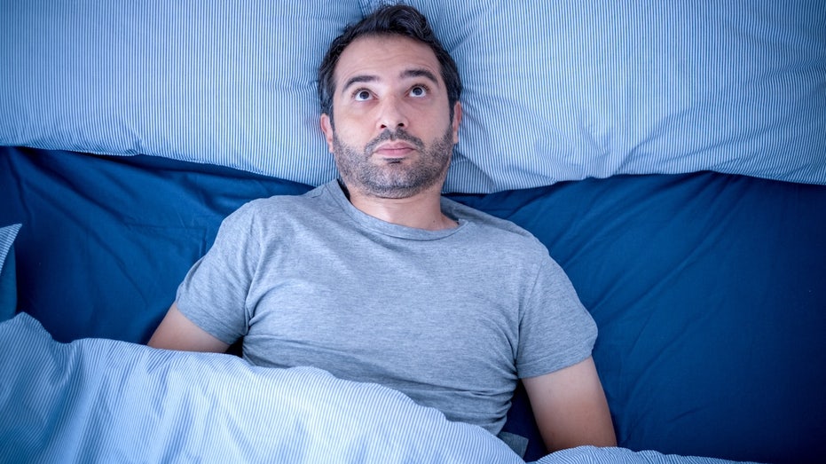 Your sleep and activity patterns may reveal hidden brain health risk, study suggests Man awake at night cant sleep.jpg