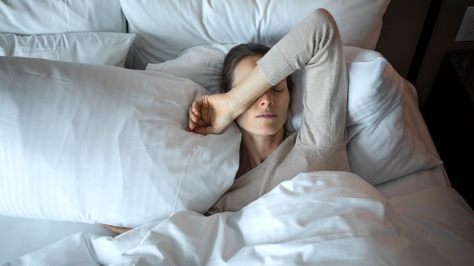 Missing sleep may take a hidden toll on your brain and longevity, research reveals Woman waking up after insomnia.jpg